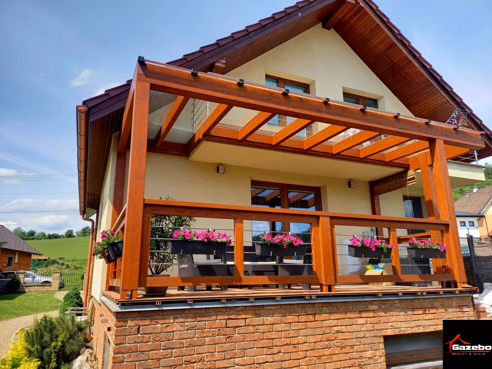 Drevená pergola Milano pri dome so sedlovou strechou a kvetmi